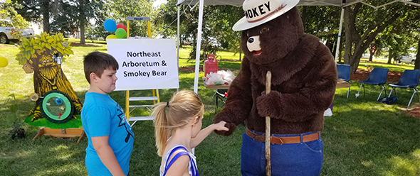 Smokey the Bear interacting with kids