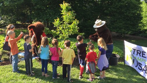 Smokey the Bear interacting with children.