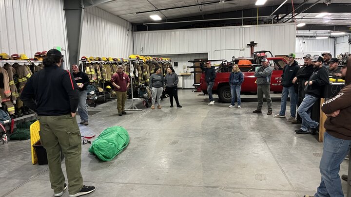 An NFS instructor prepares to show students how to deply a fire shelter