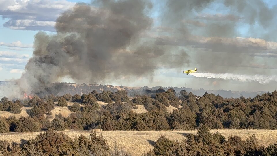 A photo of an aerial applicator targeting a fire