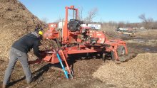 Portable sawmill processing ash log. 